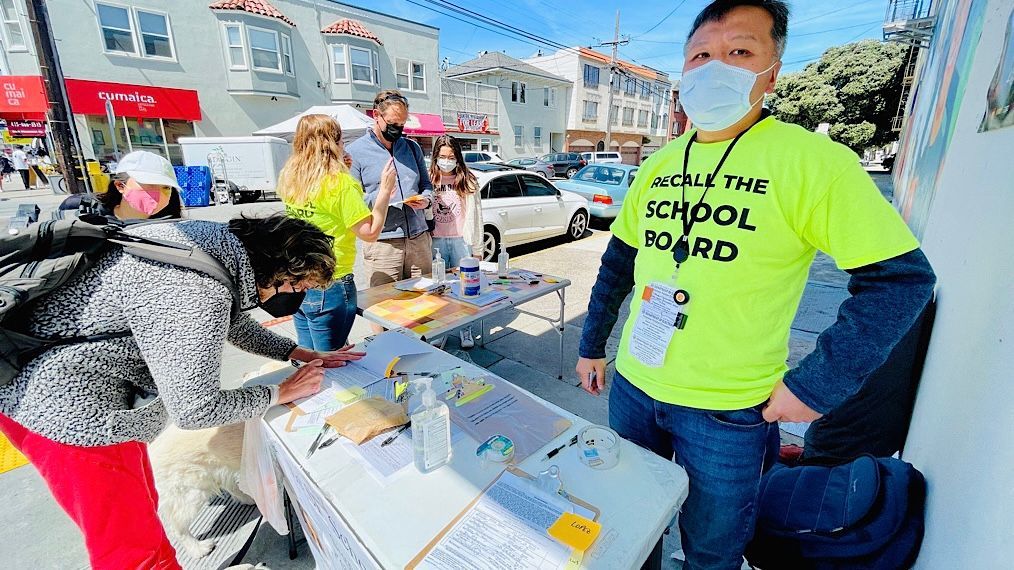 Volunteer parent Kit Lam organizes a recall school board petition drive every Sunday morning in 2021 at the Richmond Farmers Market where the stealing of the petition signatures occurred. Photo by Portia Li