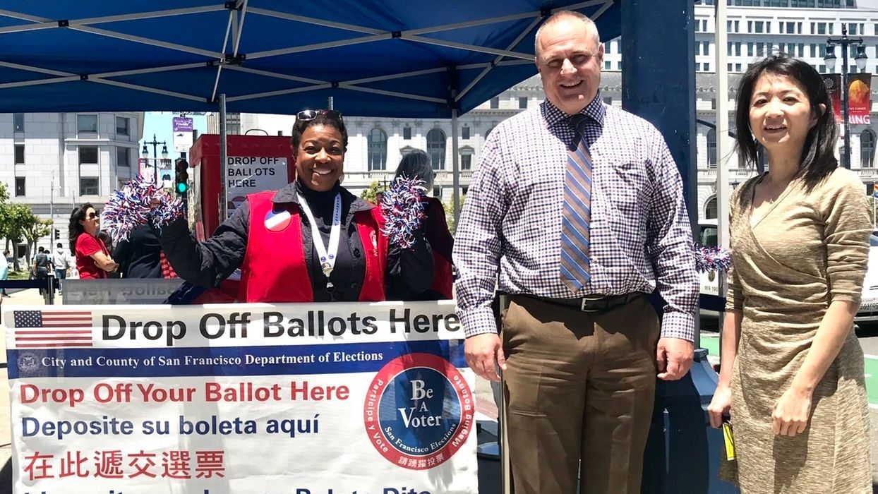 Under the leadership of John Arntz (center),Elections Department has become one of the most diverse agencies in the city. Catherine Lee (right) is one of the 37% Asian managers in the department. Photo by Portia Li