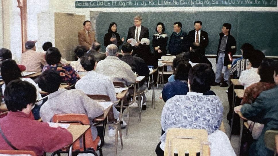 Former U.S. Immigration Services Deputy Director David Still (third from far left) visited the Pius Lee Chinese School where elderly students attended a citizenship class.