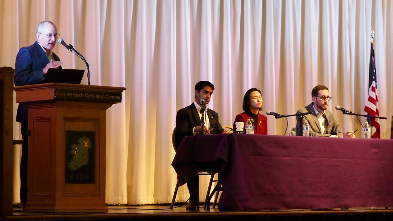 Ben Trefny (standing), Executive Producer of KALW Radio in San Francisco, moderate the Congressional candidate forum hosted by the San Francisco Independent Media Coalition. Three candidates running for the 11th District of House Representative on June 2 election to represent San Francisco at the forum are Former Chief of Staff to New York Congresswoman Alexandria Ocasio-Cortez (AOC) Saikat Chakrabarti (from 2nd left to right), San Francisco District 1 Supervisor Connie Chan, and California State Senator Scott Wiener. Photo by Ben Kwan