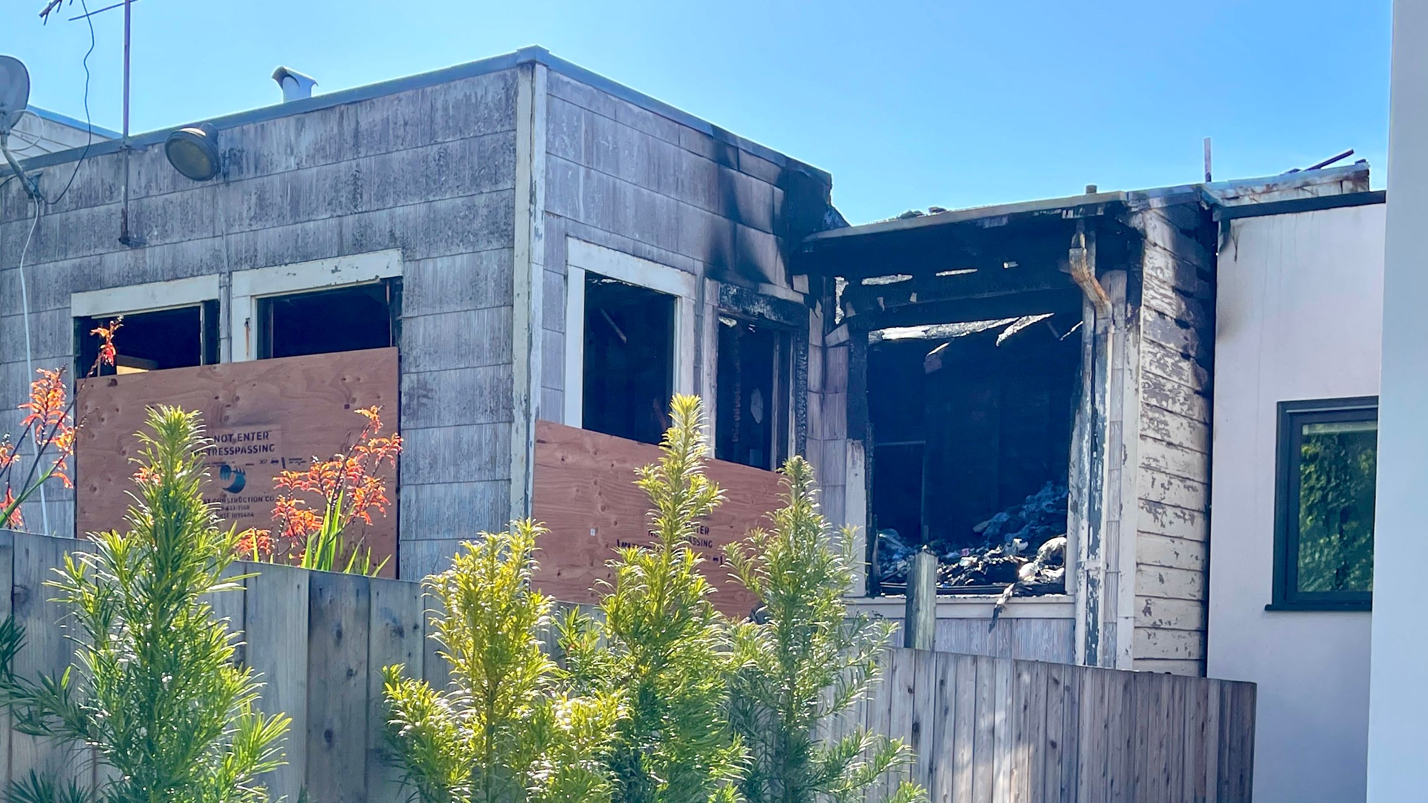 After the 1-alarm fire is controlled by the Fire Department, the house can be seen by neighbors full of things inside.  Photo by Portia Li