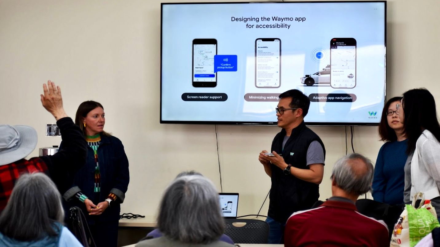 Waymo staff representatives encourage seniors to ride in the autonomous vehicles as long as they know how to use their smart phones to order the service which is available in dozens of languages including Chinese and Spanish.  Photo by Portia Li