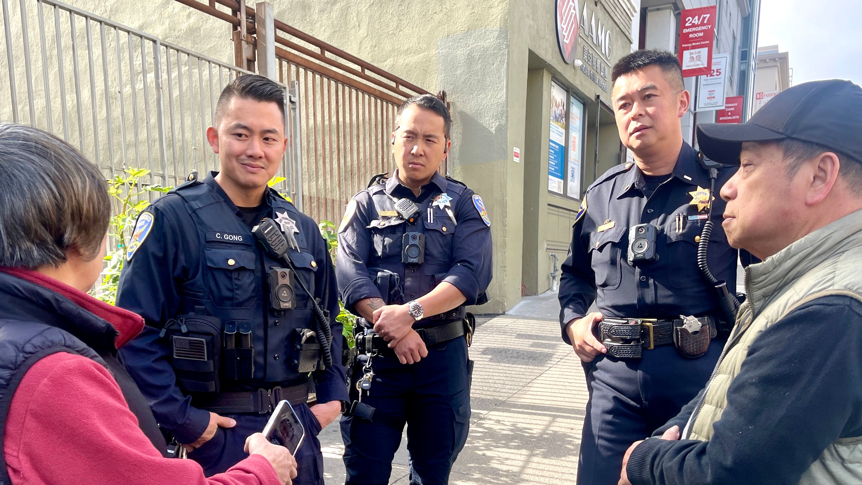Central Police Station Community Lieutenant Kin Lee (2nd from far right) and Chinatown beat officers, who all speak fluent Chinese languages, provide crime prevention information to merchants in San Francisco Chinatown. Photo by Portia Li