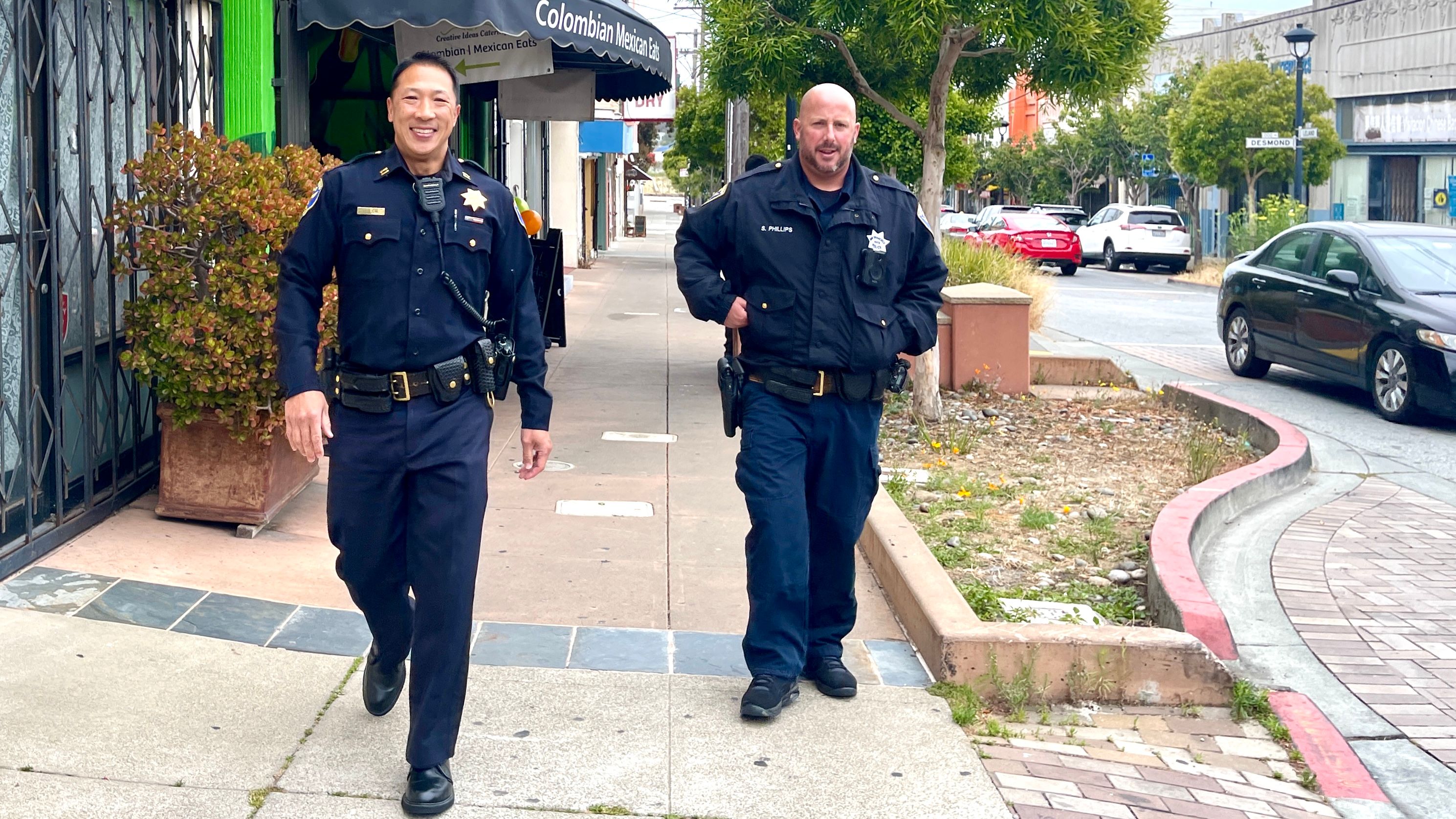Merchants remember when Incoming Police Chief Derrick Lew was the Ingleside Station Captain (left) in 2022 to 2023, he was seen very often walking the beat along the Leland Avenue corridor in Visitacion Valley. Photo by Portia Li in 2023