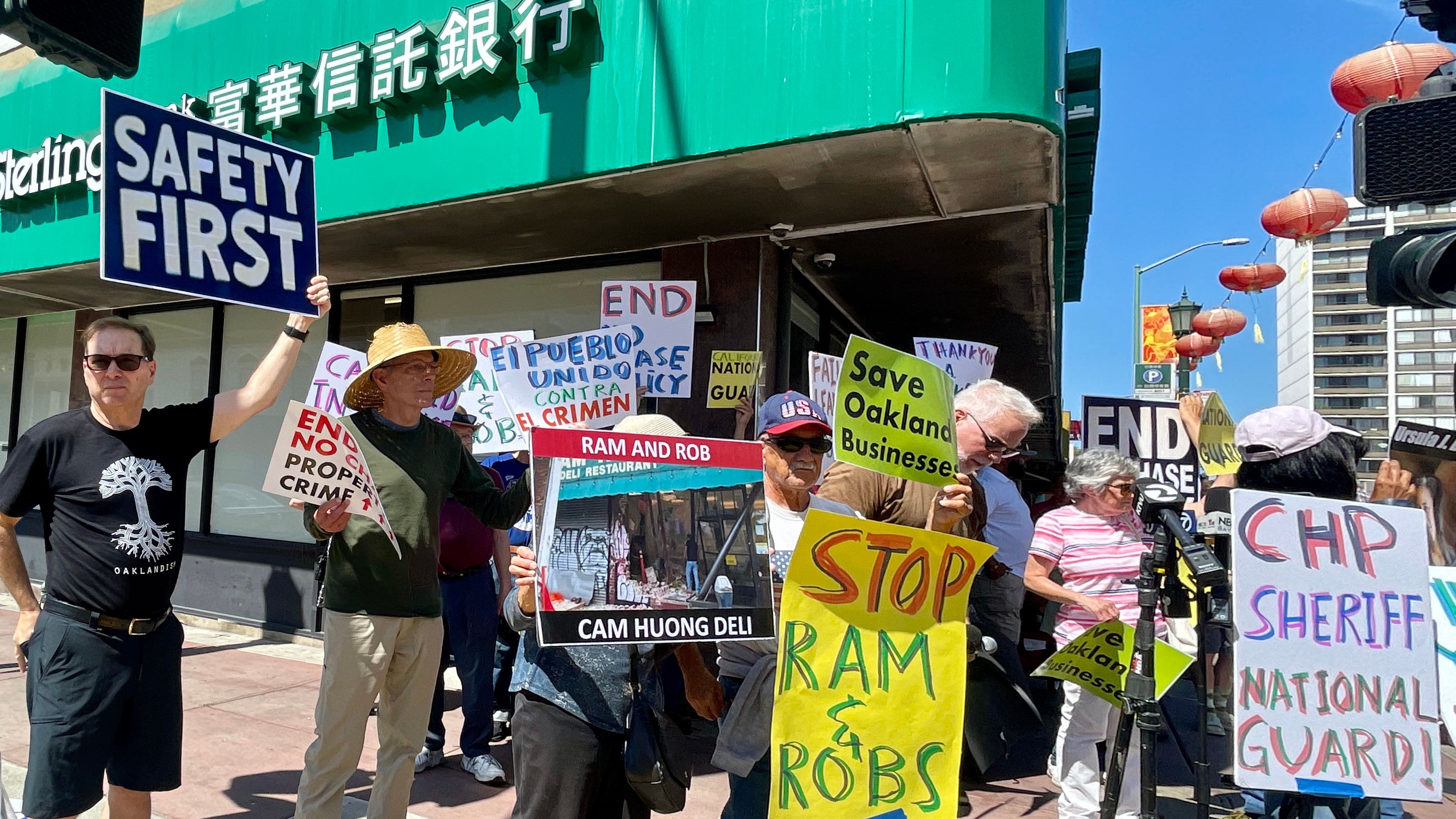 A group of individuals rallied in front of the Sterling Bank and Trust, which was damaged by the burglars in Oakland Chinatown, calling for safer streets. Photo by Portia Li