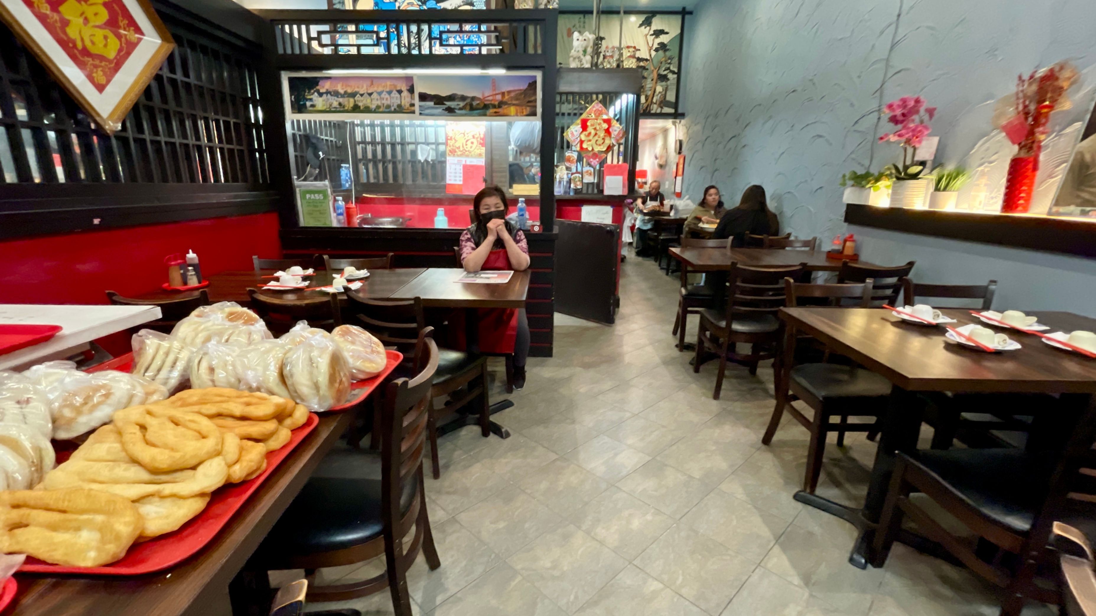 Shu Bo Wang is waiting for customers walking in her Happy Family Gourmet Dumplings restaurant which has lost 70% revenue since January 2024. Photo by Portia Li