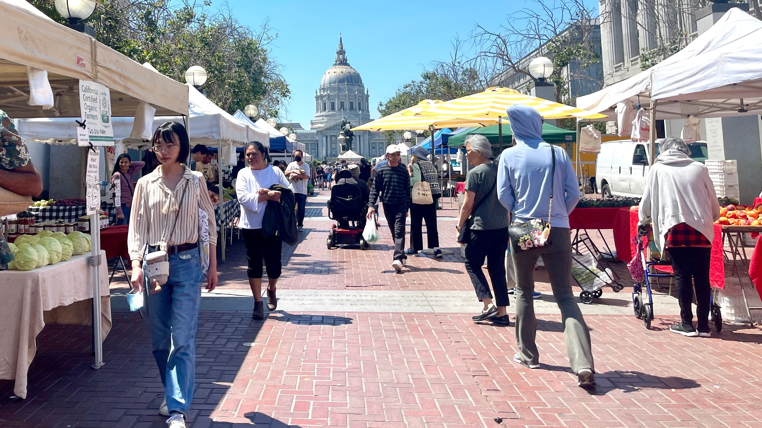 The brick-lined pavement farmers’ market at the United Nations Plaza will be moved by the City to the nearby Fulton Street parking lot starting September 3. Photo by Portia Li