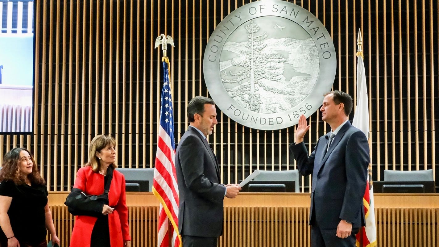 Newly-appointed San Mateo County Sheriff Kenneth Binder (right) is sworn into office by San Mateo County Supervisor Ray Mueller. Supervisors Noelia Corzo (from far left) and Jackie Speier are present. Courtesy San Mateo County Office 