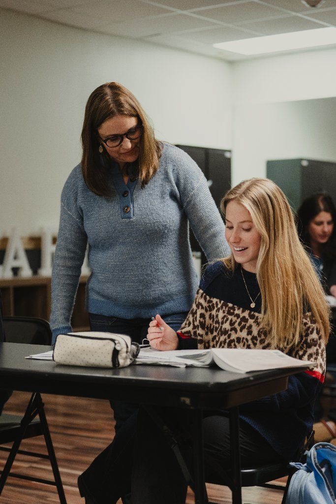 Teacher guiding student