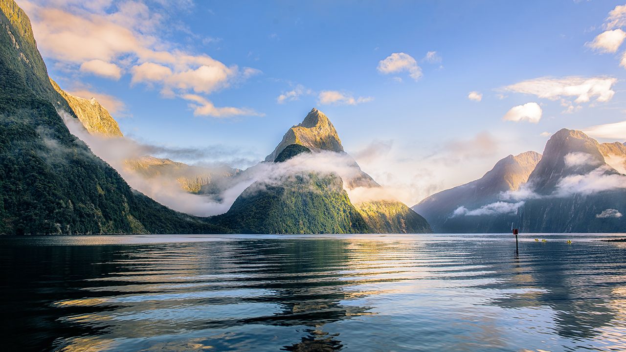 Mitre Peak rising above Milford Sound under cloud