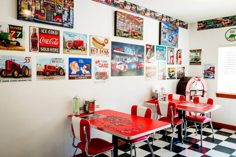 Gardens on Quail 1950s soda shop with vintage signs, red tables, and jukebox