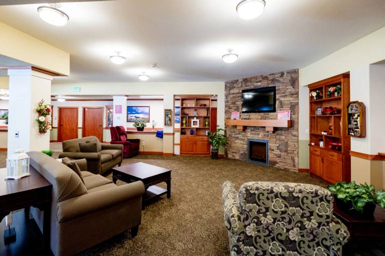 Memory care living room in the secure Gardens on Quail community lounge