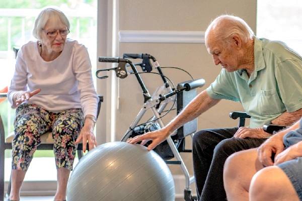 Golden Pond residents doing seated exercise with a stability ball