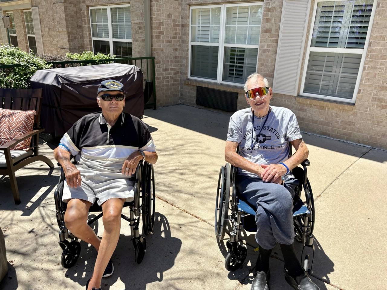 Two Gardens at Columbine residents seated on the patio in summer attire