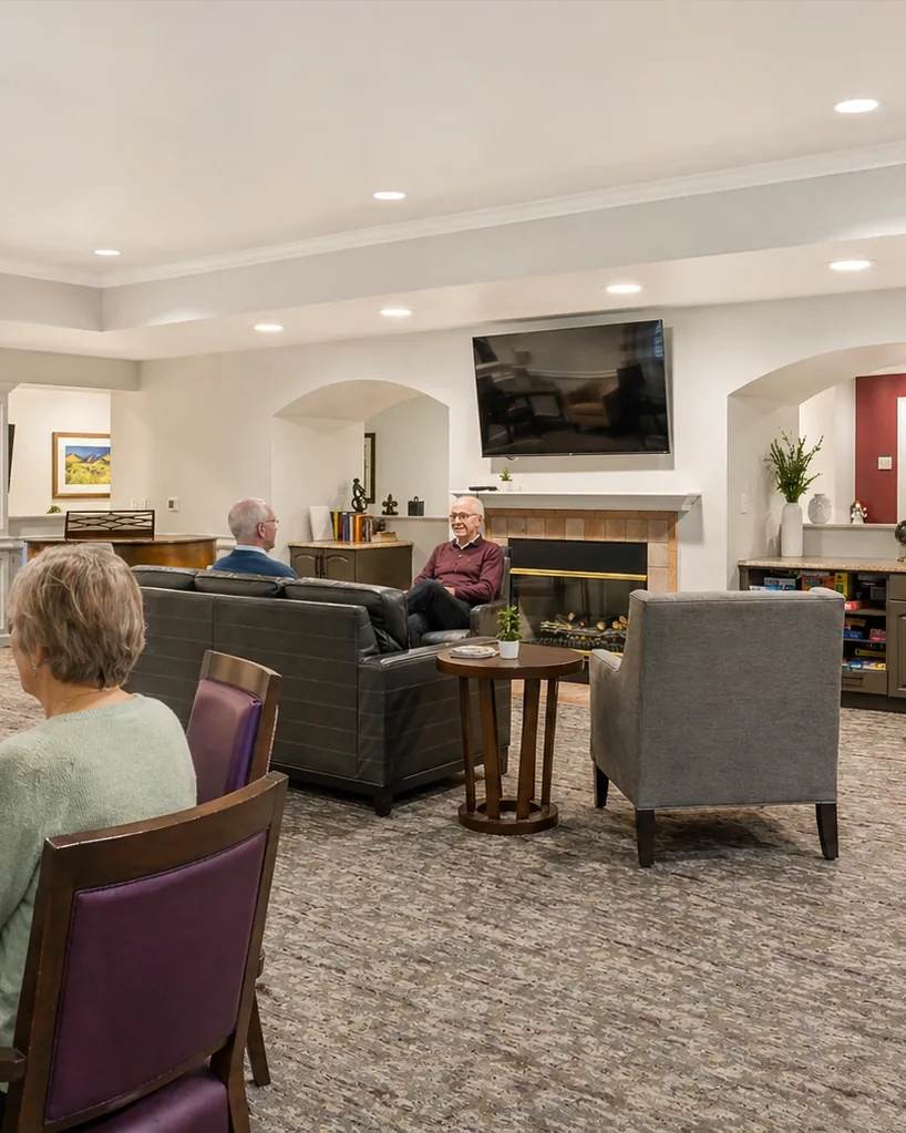 Bear Creek residents winding down together at a puzzle table and fireplace seating area