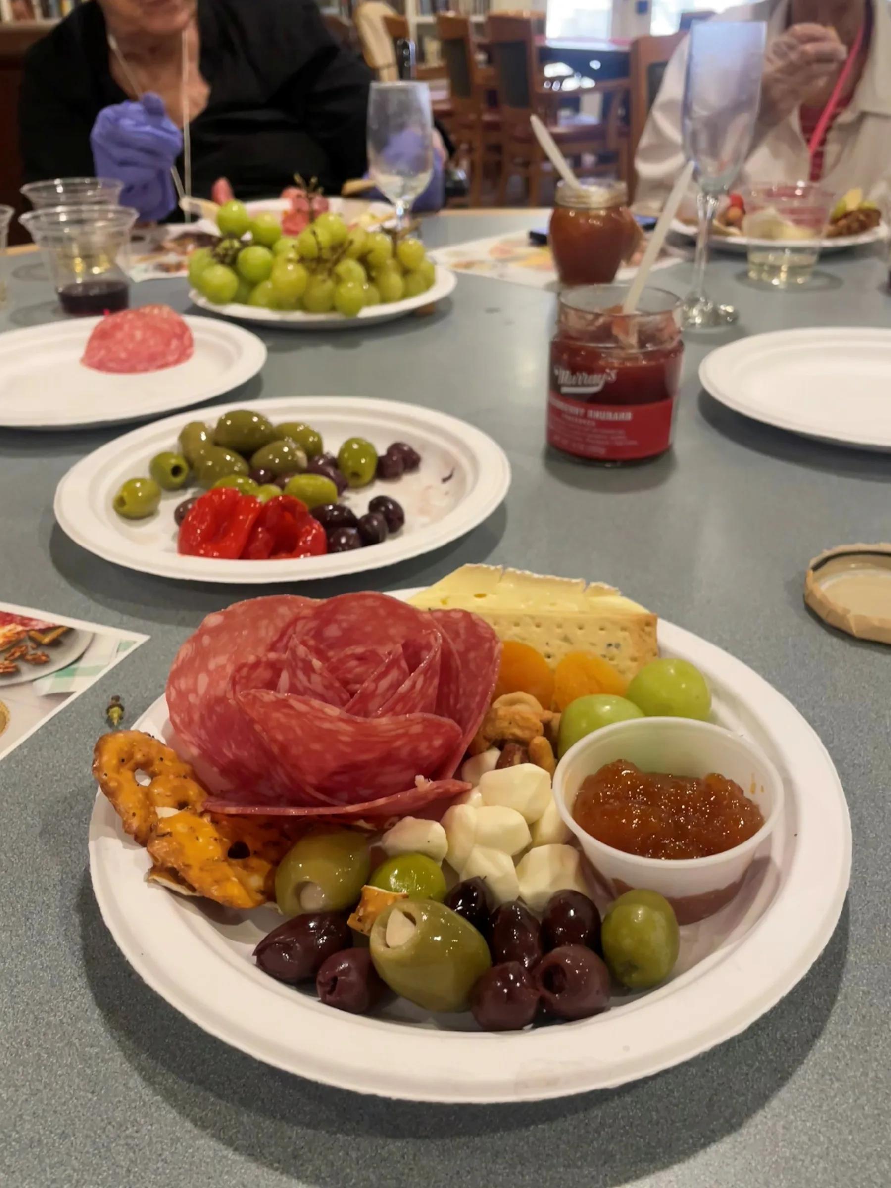 Charcuterie plate with olives, cheese, salami, grapes, and jam at Gardens at Columbine
