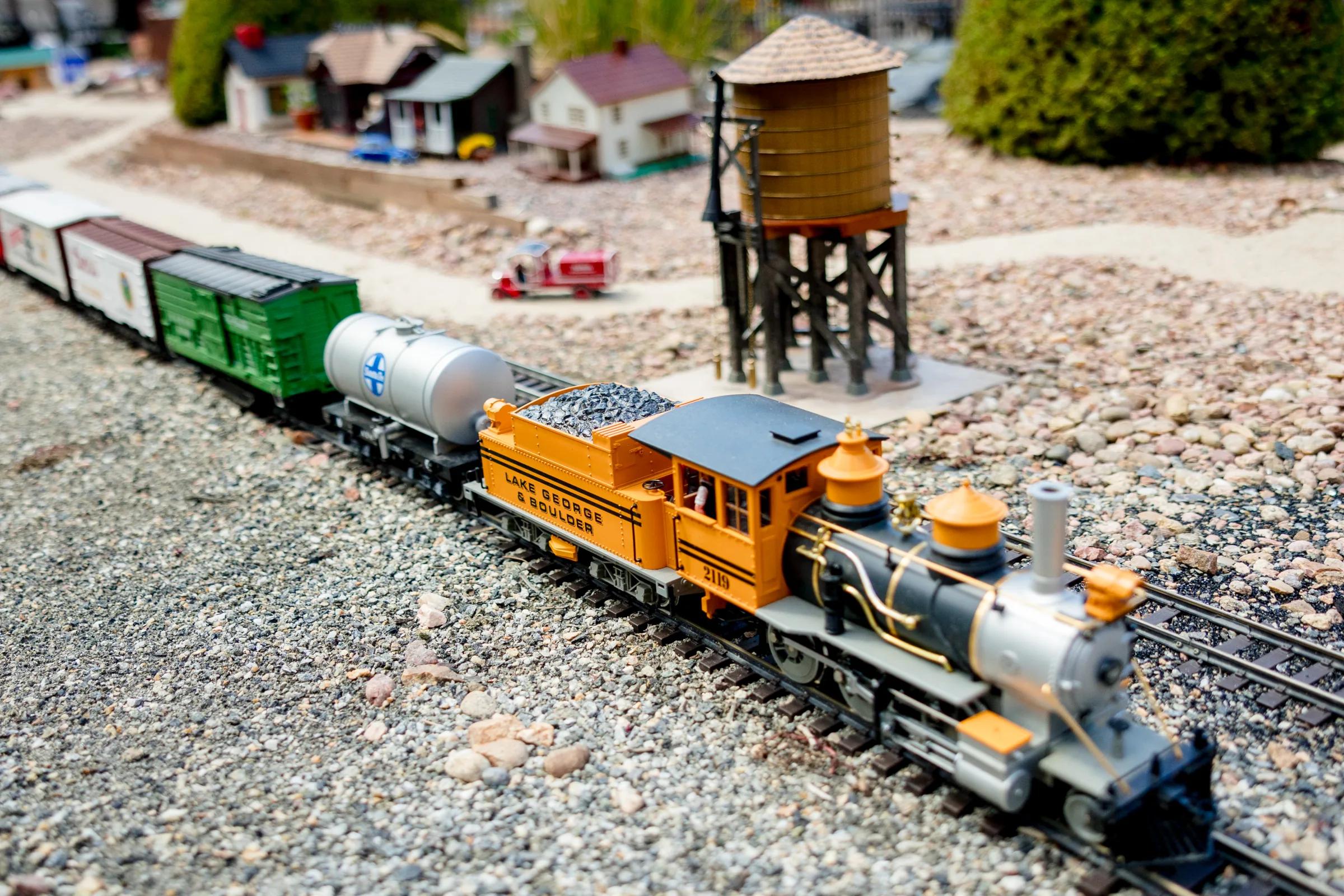 Close-up of the Lake George Railway locomotive and cars in the Gardens on Quail train garden
