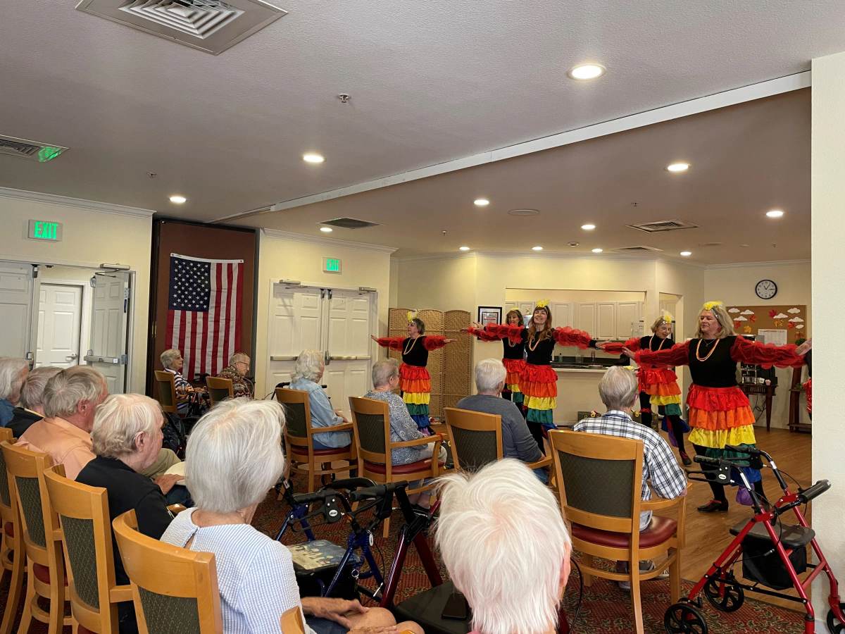 Gardens at Columbine residents watching a colorful Latin dance performance