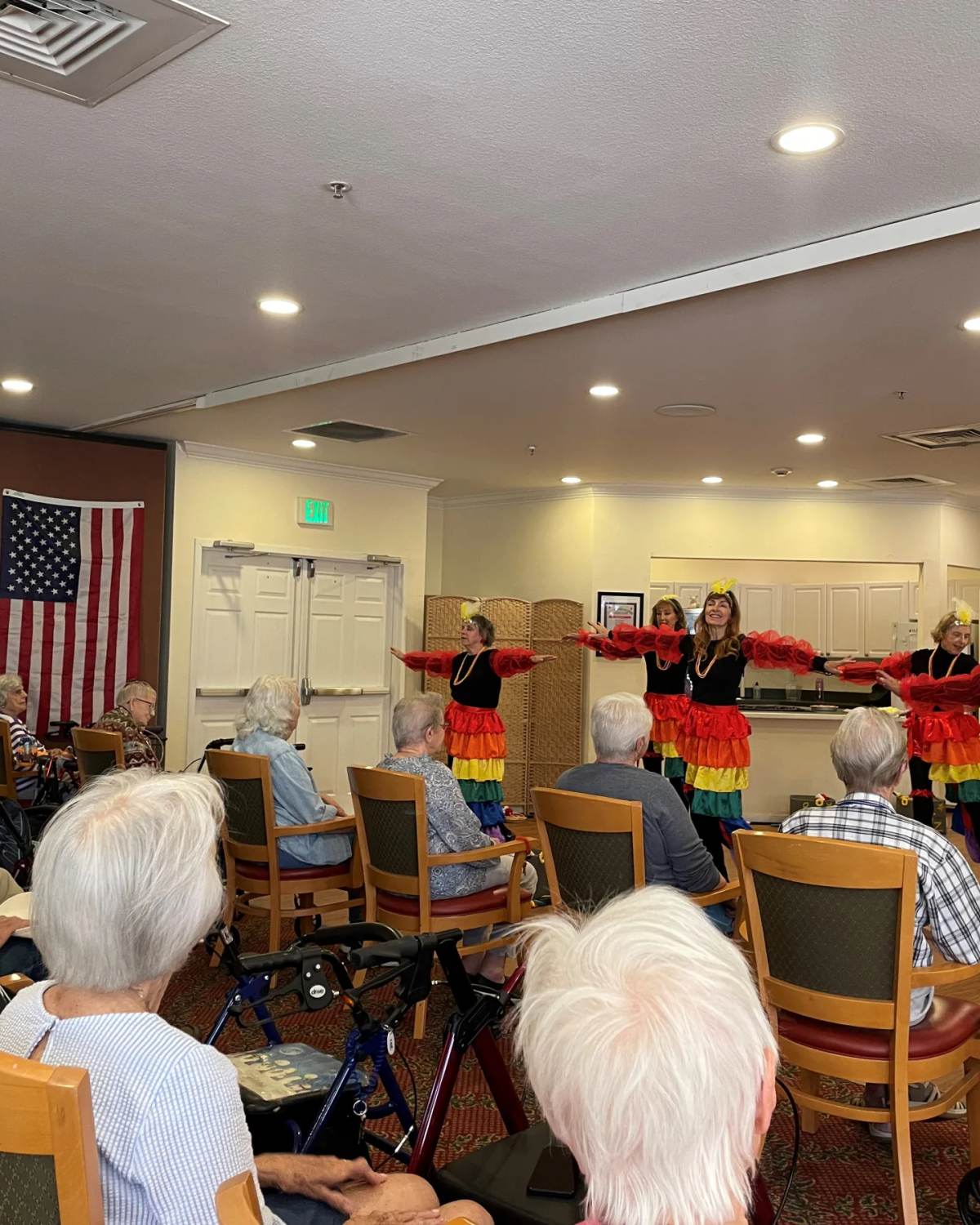 Gardens at Columbine residents watching a colorful Latin dance performance