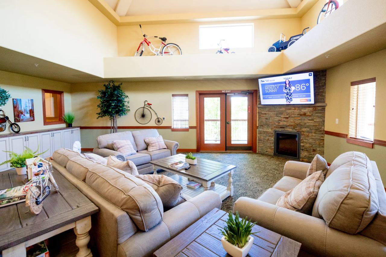 Gardens on Quail lounge with vintage bicycles displayed on a loft railing over the fireplace