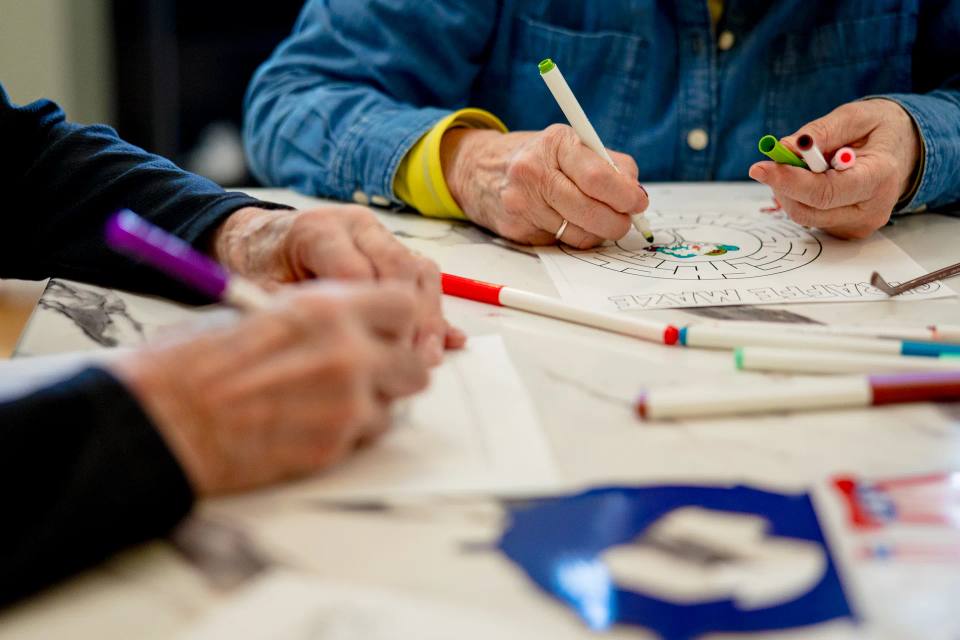 Residents coloring together during a creative activity at Stonebridge Senior