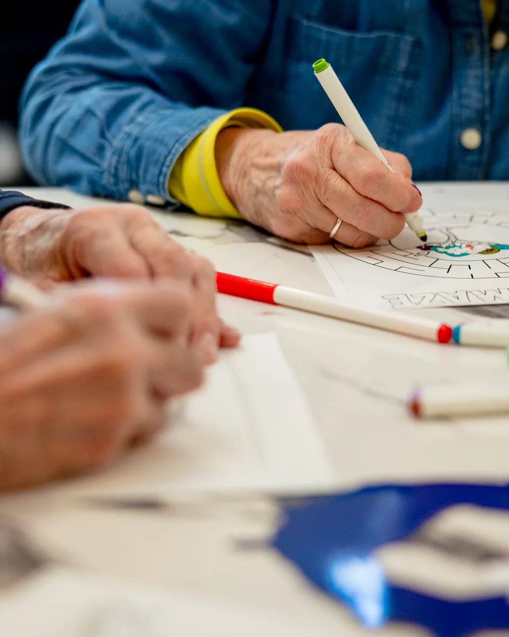 Residents coloring together during a creative activity at Stonebridge Senior