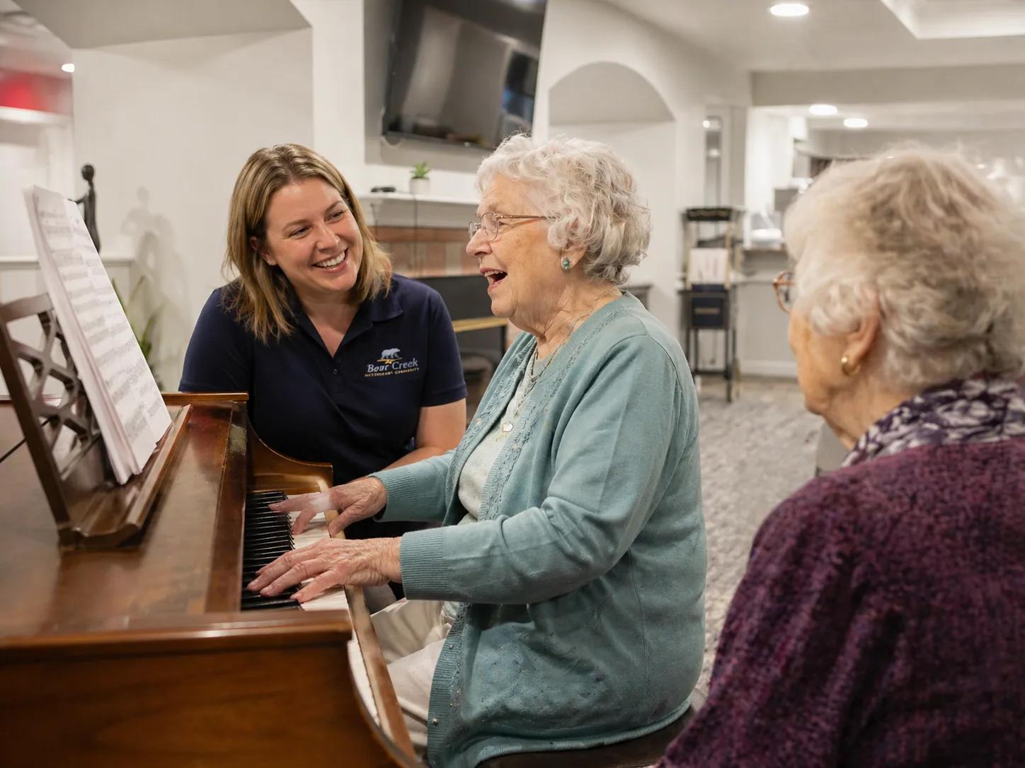 Bear Creek residents enjoying a piano activity with a care team member.