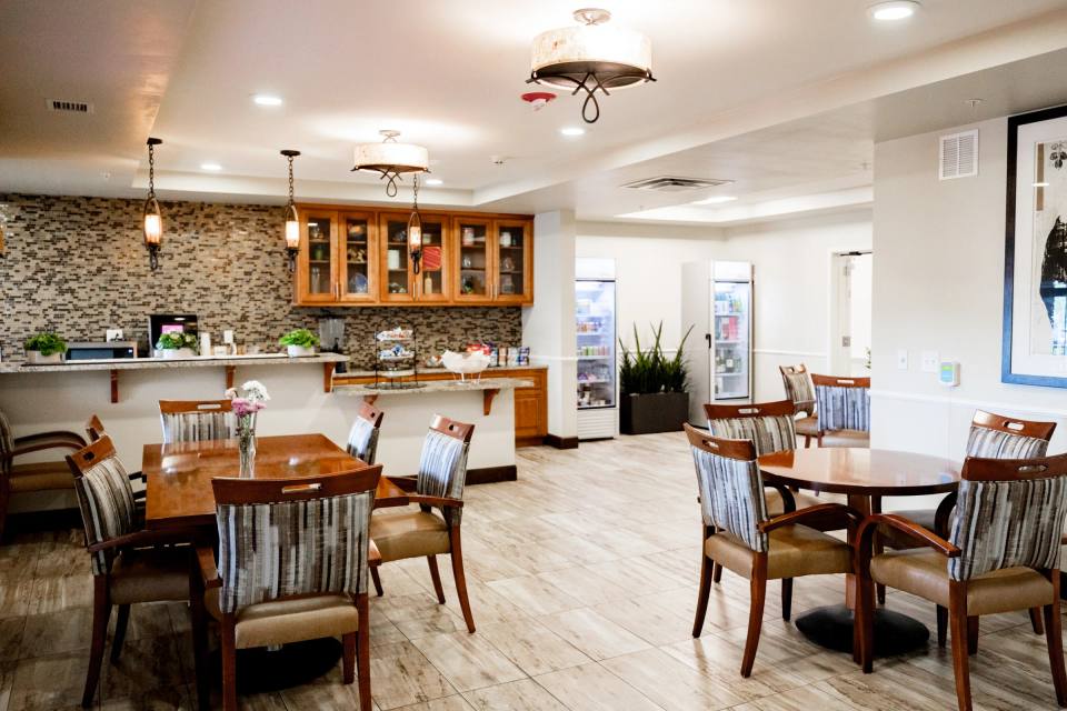 Stonebridge bistro with stone backsplash, pendant lights, and open seating