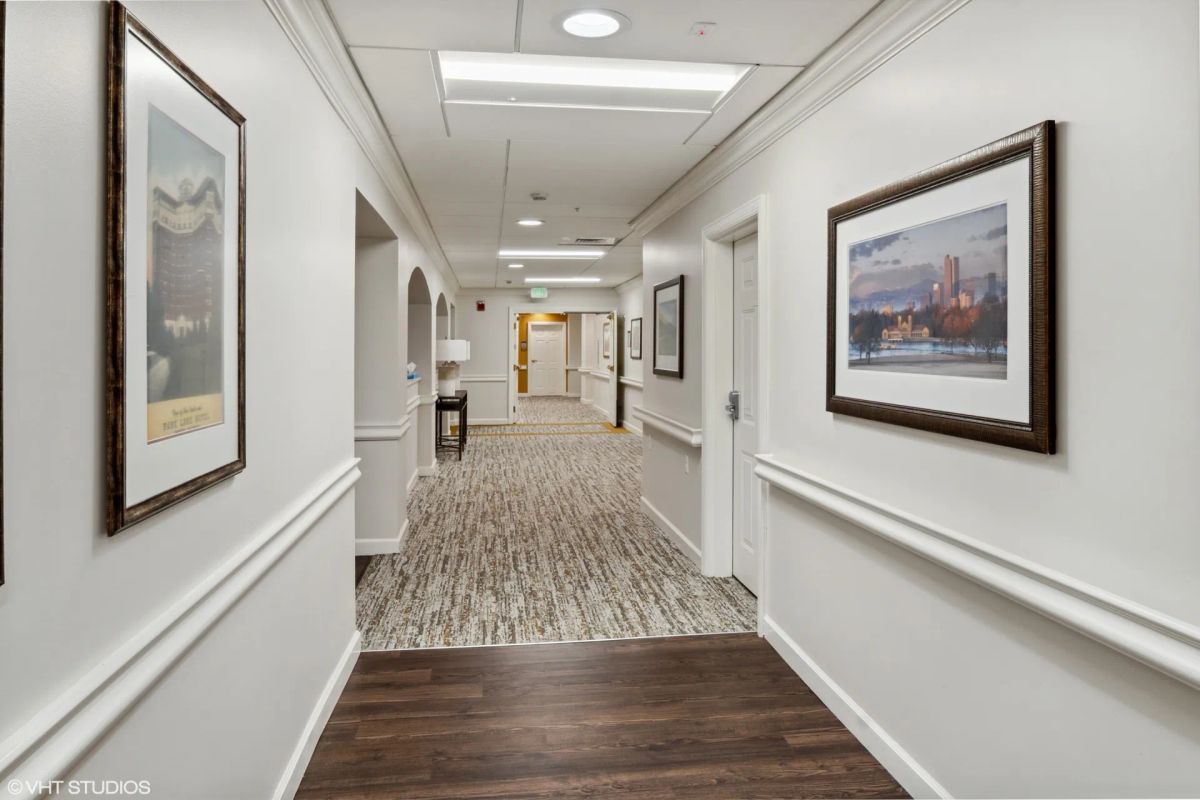 Remodeled hallway at Bear Creek in Lakewood with clear wayfinding for dementia care support.