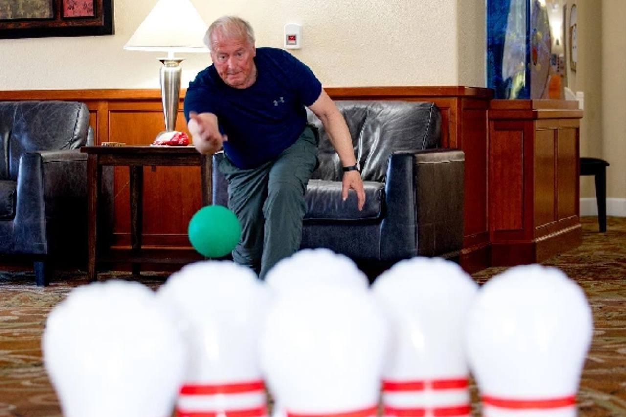 Golden Pond resident bowling in a community lounge