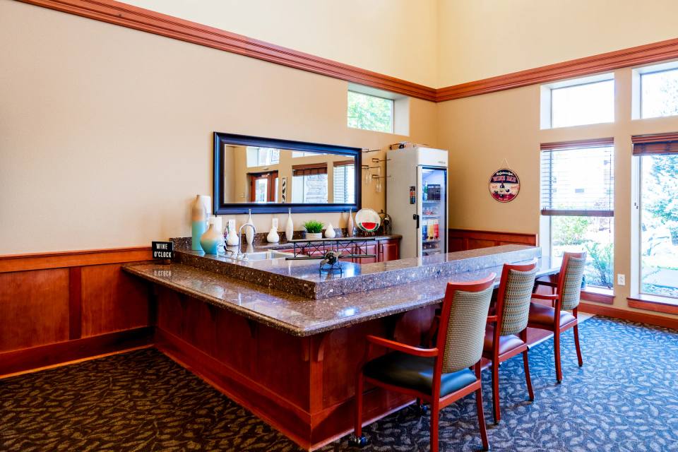 Gardens on Quail wine bar with bar stools, granite counter, and window seating