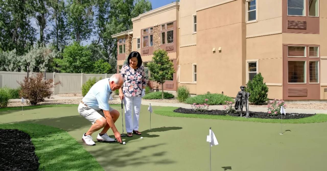 Gardens on Quail resident couple on the outdoor putting green beside the residence