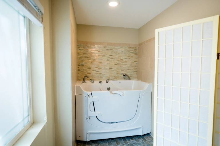 Walk-in therapeutic tub in a private bathing suite at Stonebridge Senior