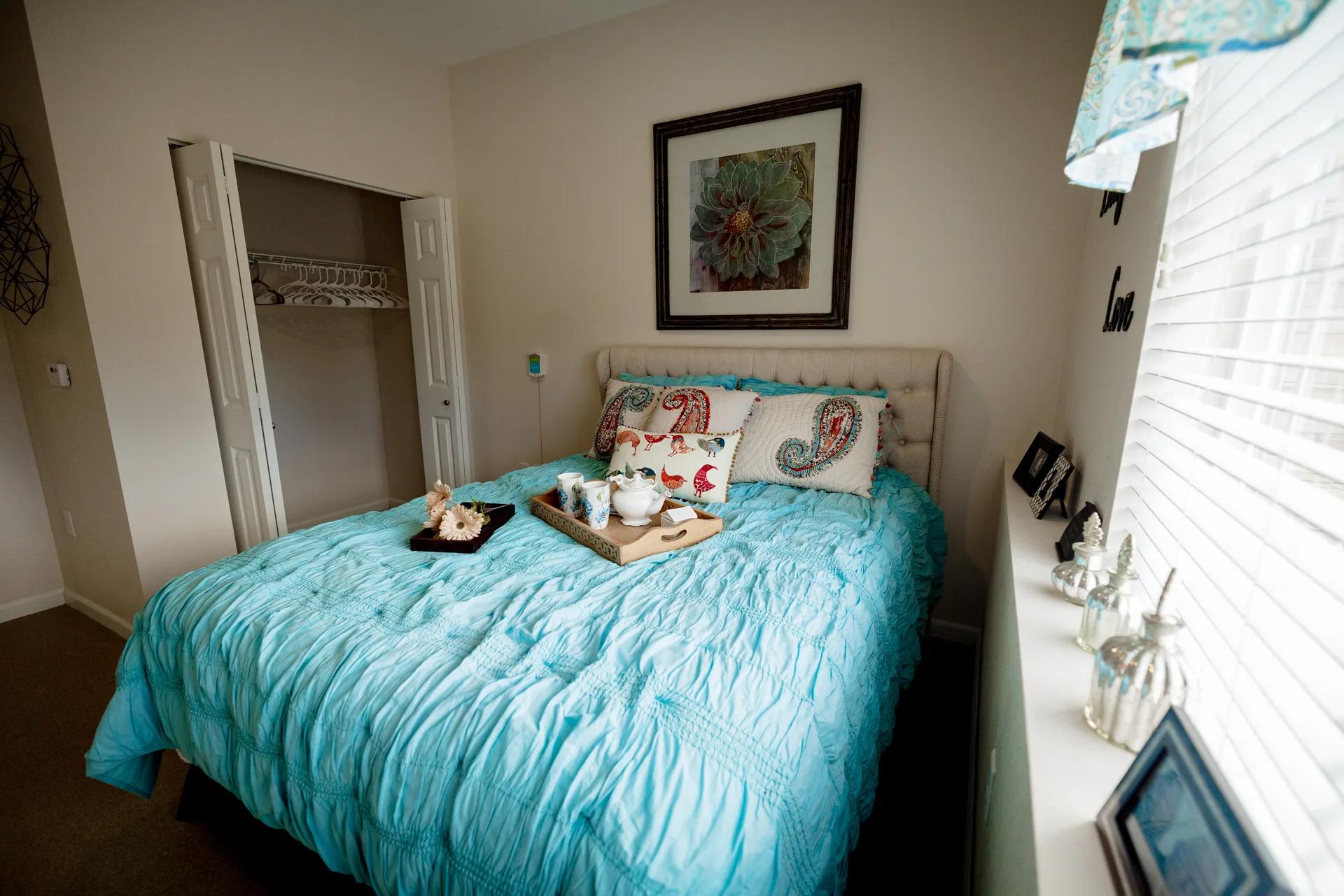 Stonebridge Senior apartment bedroom with turquoise bedding and window light