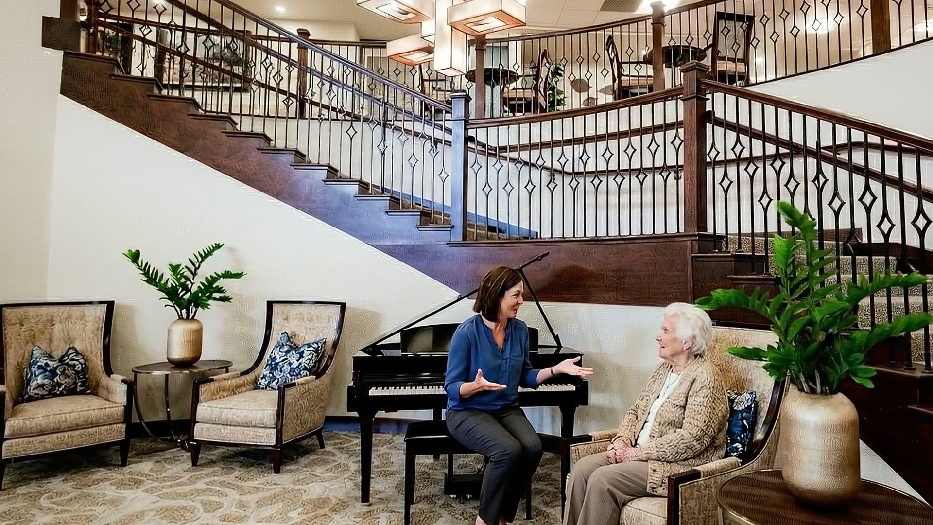 Stonebridge team member visiting with a resident in the lobby