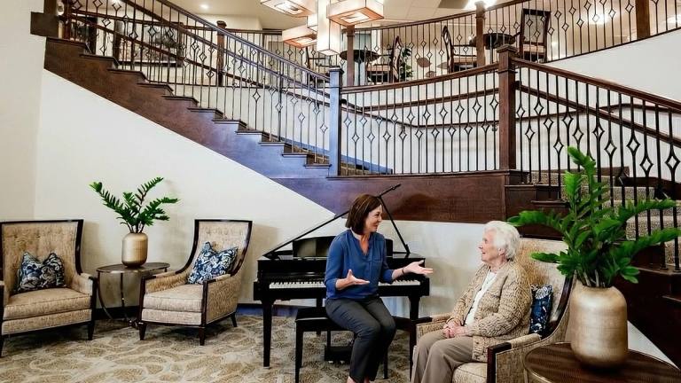Stonebridge team member visiting with a resident in the lobby