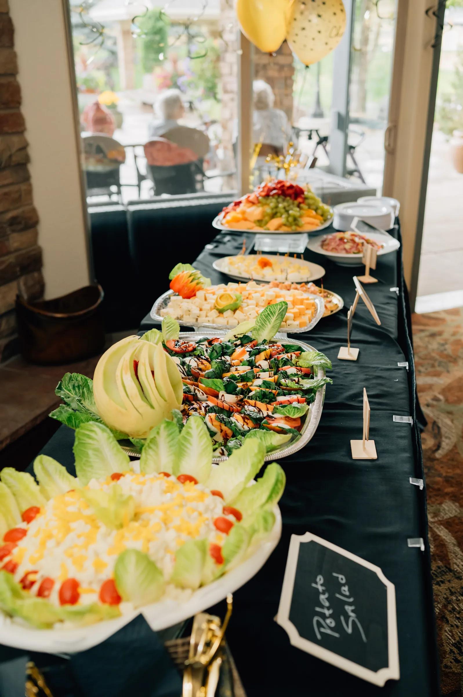 Golden Pond event buffet line with salads, potato salad, and fresh sides