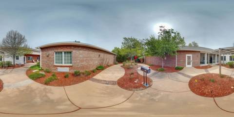360 panorama of Bear Creek's brick courtyard with walkway, garden beds, and mailbox