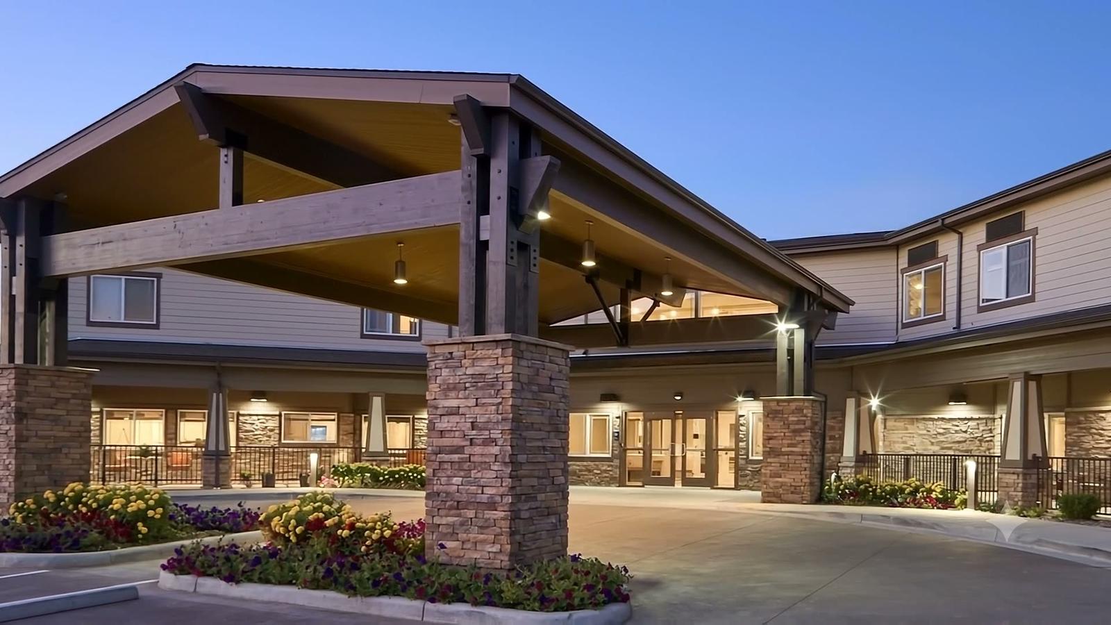 Stonebridge Senior main entrance and covered arrival area at dusk