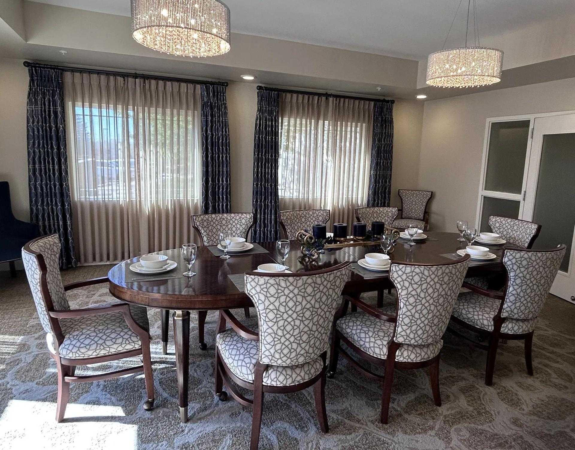 Stonebridge Senior private dining room with a set table and chandeliers