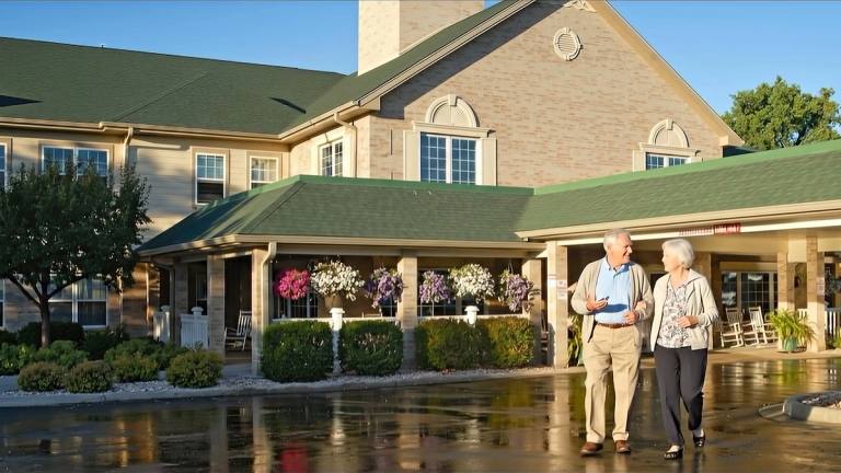 Gardens at Columbine residents walking near the main entrance
