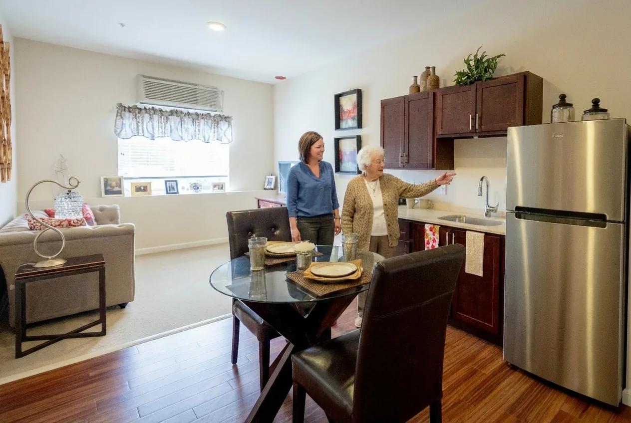 Stonebridge Senior apartment kitchenette and dining area during a resident visit.
