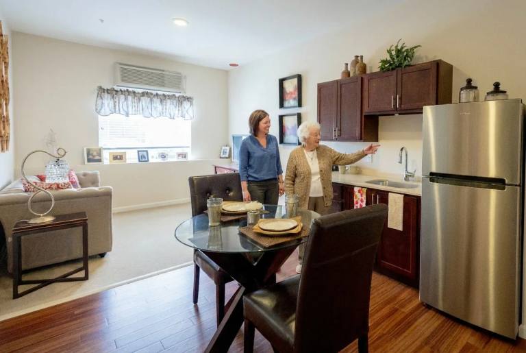 Stonebridge Senior apartment kitchenette and dining area during a resident visit.