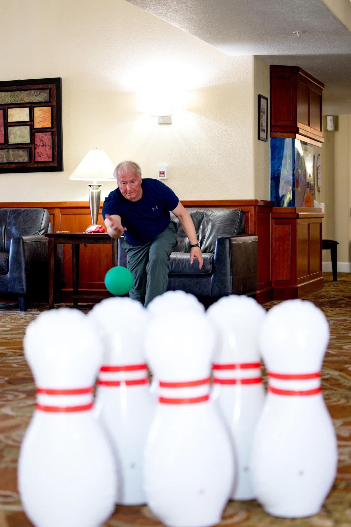 Resident bowling during an indoor community activity