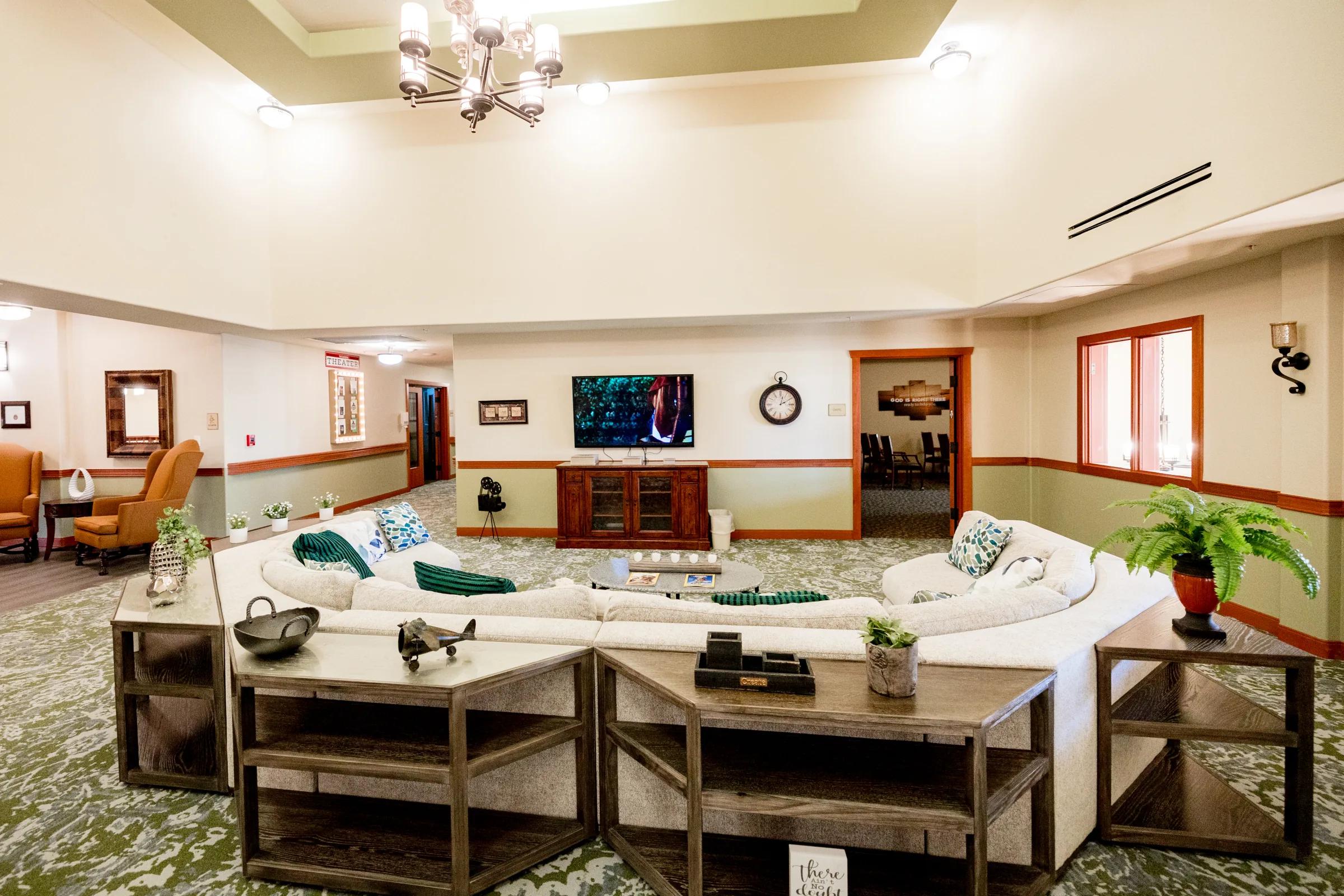 Gardens on Quail family room with a white sectional sofa and television armoire