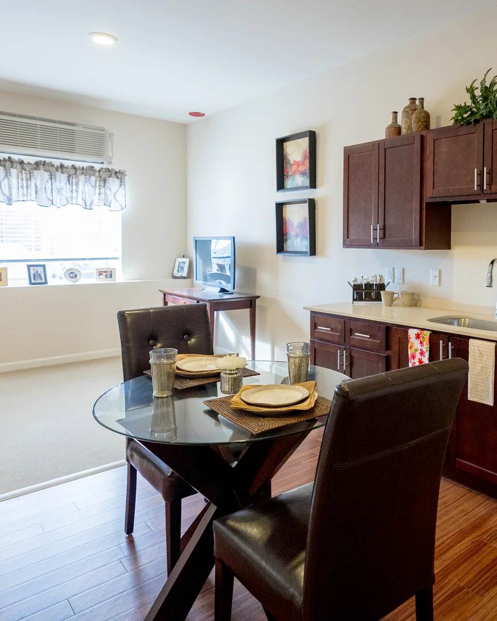 Stonebridge Senior apartment kitchenette, dining table, and living area