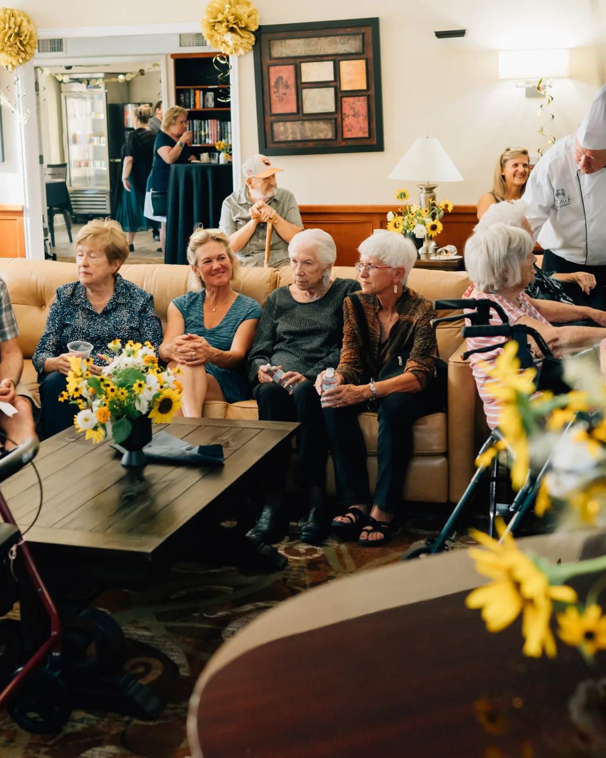 Golden Pond residents gathered in the living room lounge with chef and staff