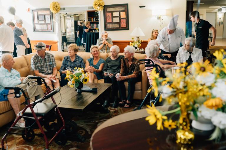 Golden Pond residents gathered in the living room lounge with chef and staff