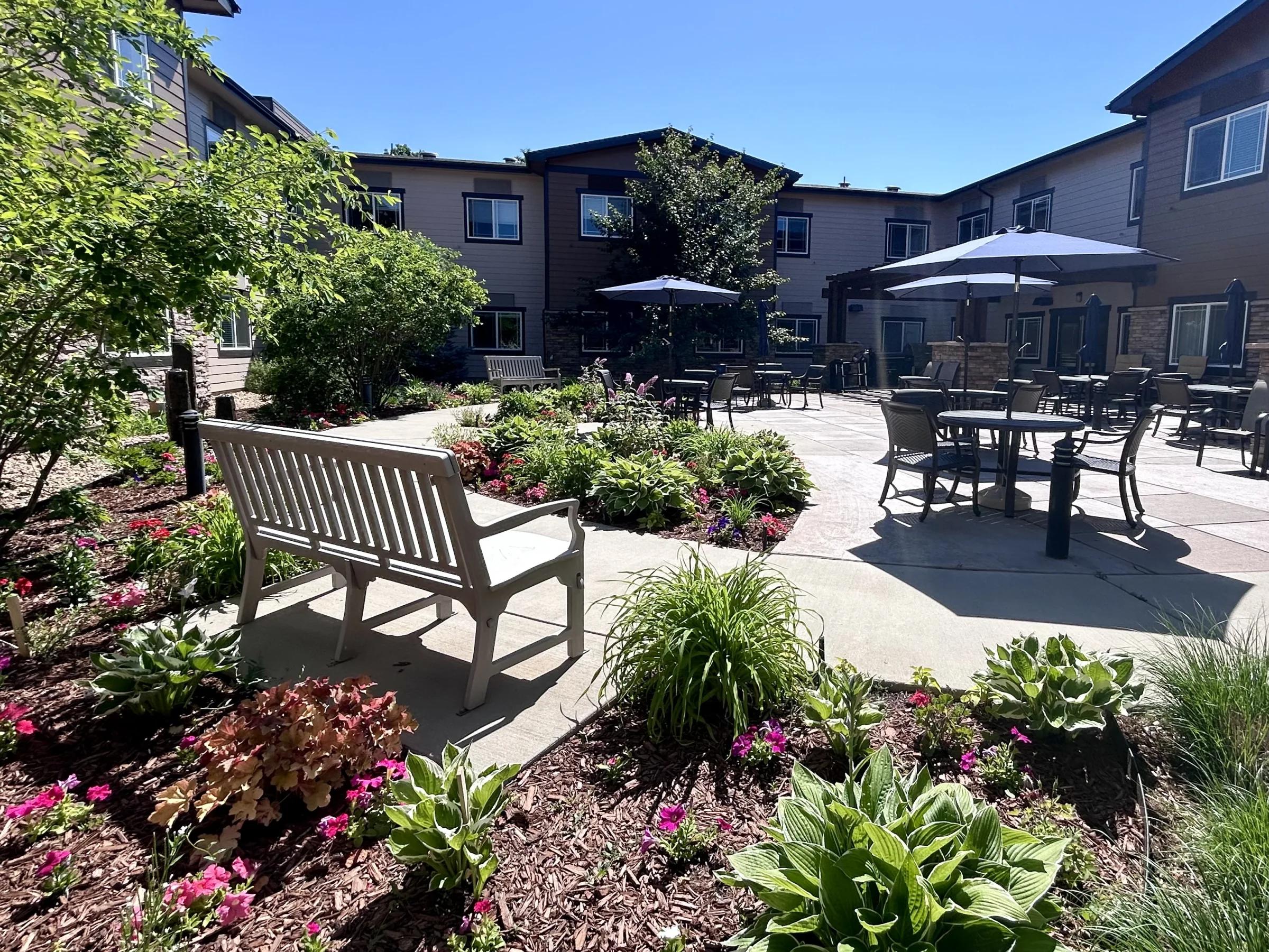 Stonebridge courtyard garden with bench and umbrella patio seating