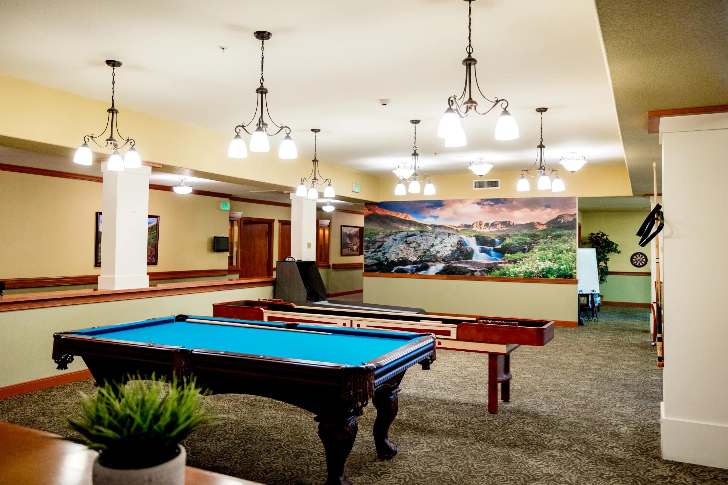 Gardens on Quail billiards room with pool table, shuffleboard, and Colorado mural